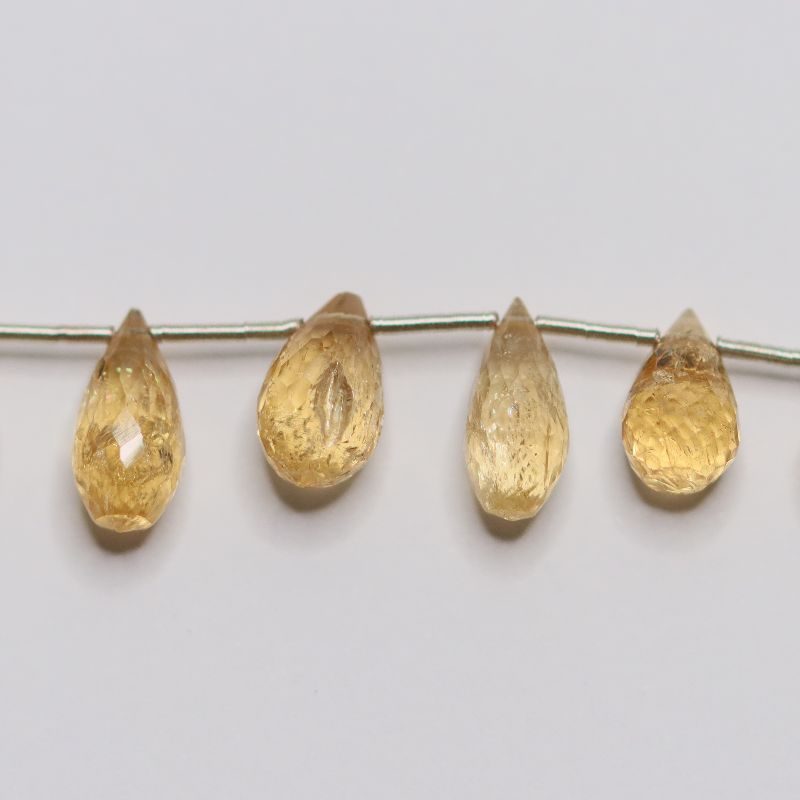 YELLOW TOPAZ 24 PER STRING 7X3.5-12X5 GRADUATED FACETED PEAR BRIOLETTE